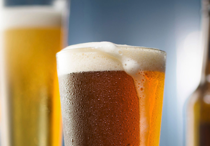 Foam overflowing from a crisp pint